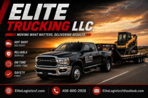 Elite Trucking LLC black RAM hot shot truck hauling a skid steer loader on a gooseneck flatbed trailer at sunset, featuring company branding, website, phone number, and email contact information.