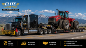 Elite Logistics semi-truck hauling a four-wheel-drive articulated farm tractor with wide dual tires on a step deck trailer displaying an oversized load sign for heavy equipment transport.