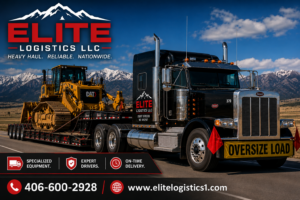 Elite Logistics LLC heavy haul flatbed truck hauling an oversized bulldozer on a lowboy trailer down a highway with snow-capped mountains in the background and oversized load safety banners displayed.