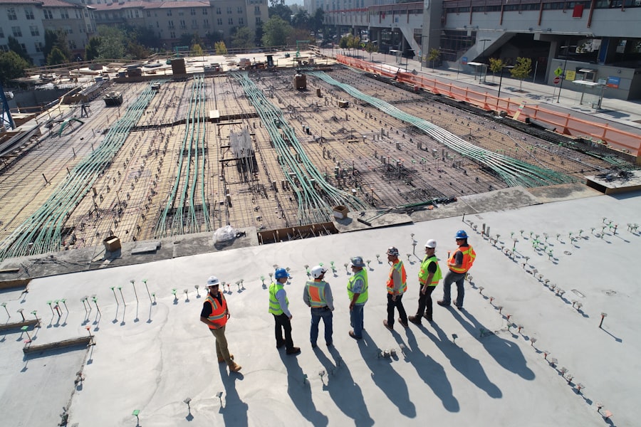 Construction workers inspecting large concrete slab