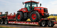 Orange-red farm tractor secured on a red flatbed trailer for tractor hauling and farm equipment transport