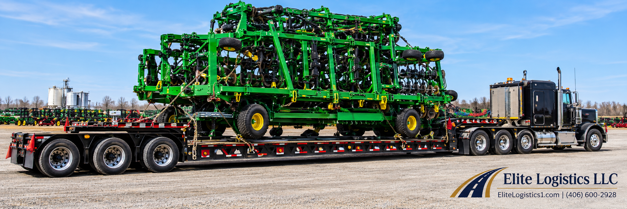Black semi-truck hauling a large folded green agricultural implement on a lowboy trailer.