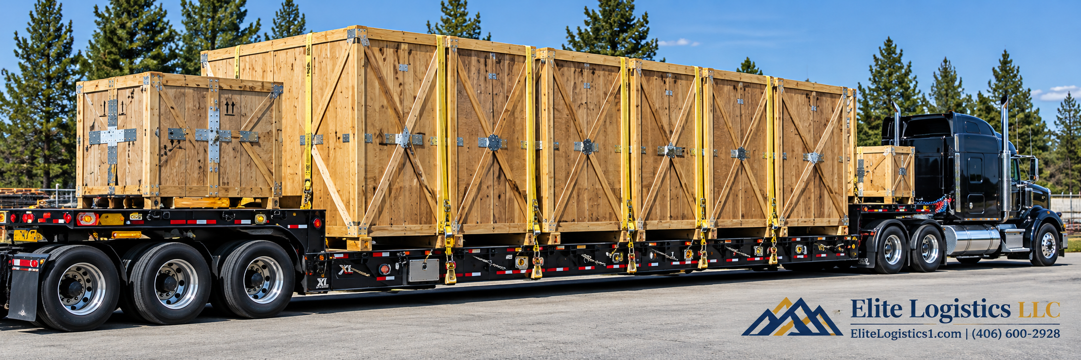 Black semi-truck hauling large wooden shipping crates secured with yellow straps on a flatbed trailer.