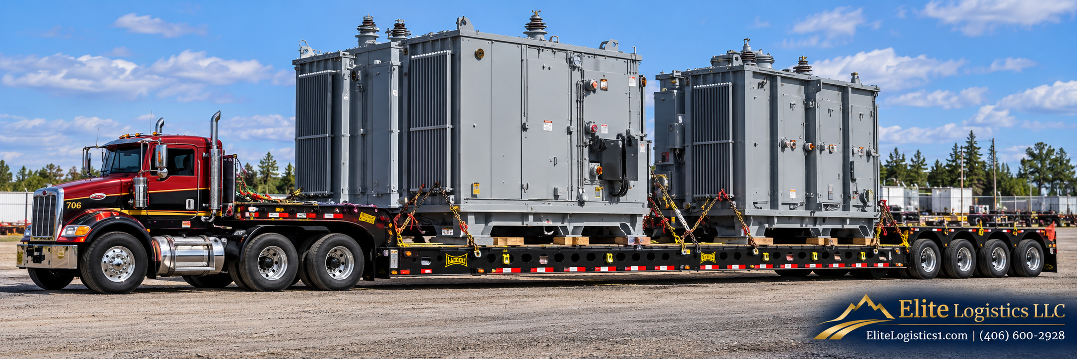 Red semi truck hauling two large electrical transformers secured on a lowboy trailer, with Elite Logistics branding.