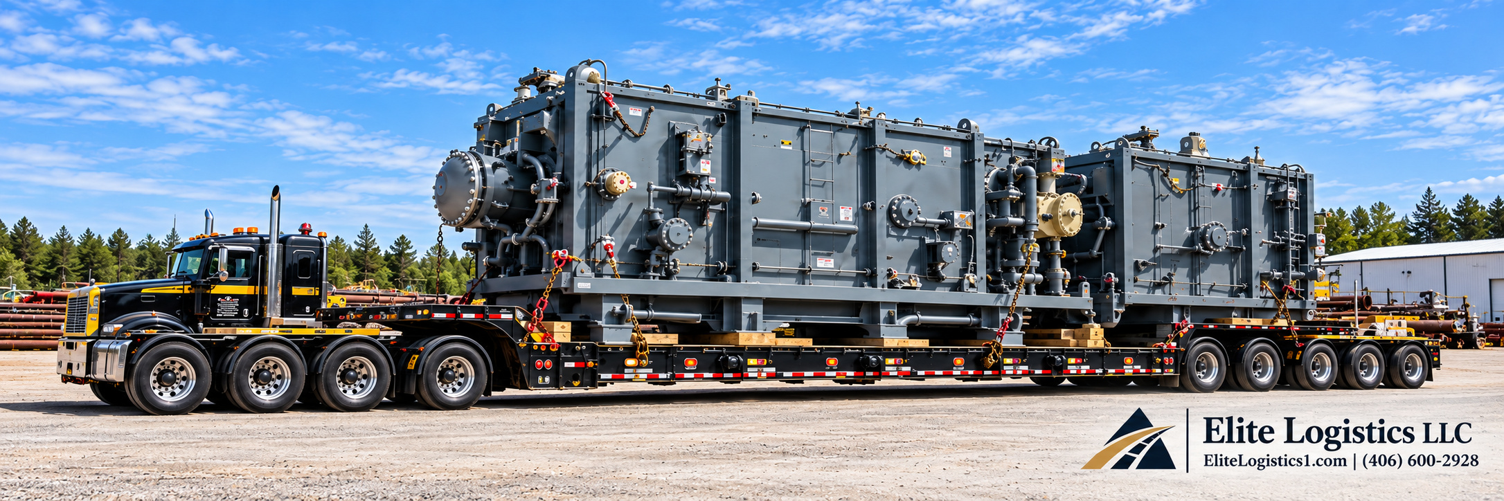 Black semi-truck hauling large gray industrial machinery on a multi-axle lowboy trailer.