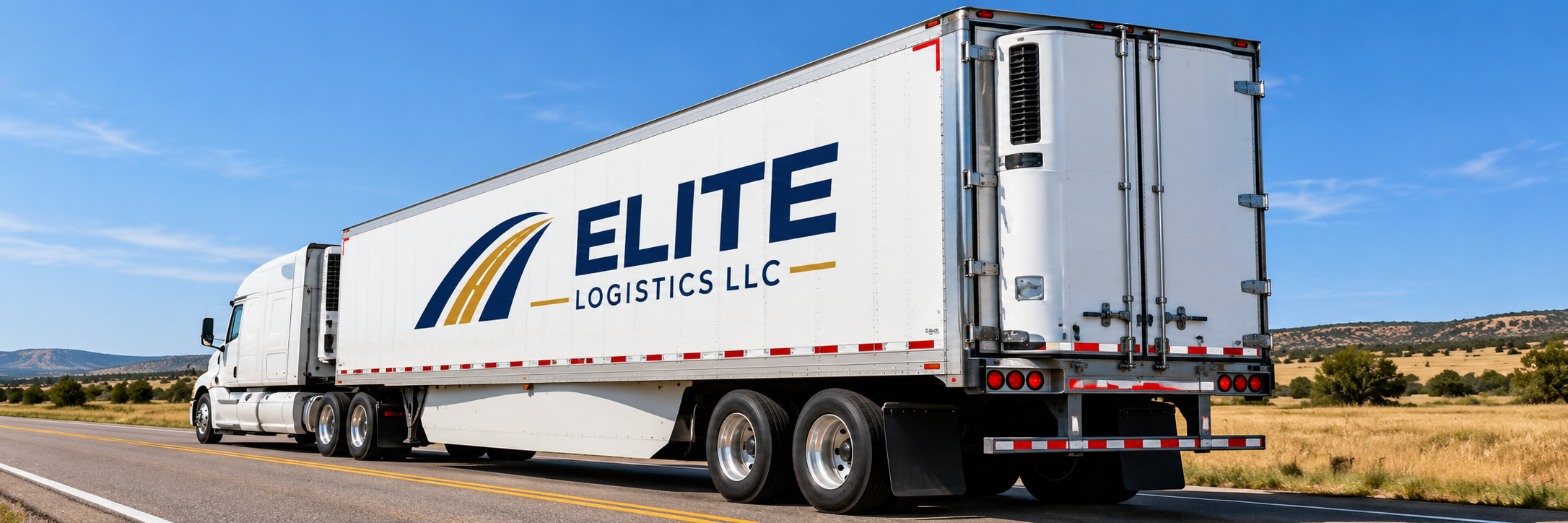 White Elite Logistics refrigerated trailer viewed from the rear at an angle on a rural highway.