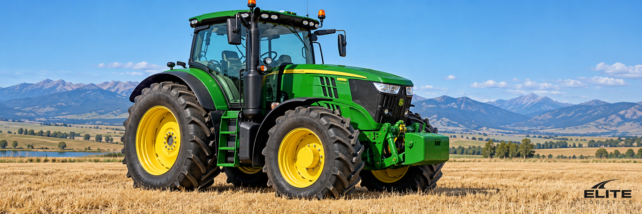 Green agricultural tractor with yellow wheels in a Montana field, representing Elite Logistics tractor hauling.